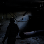 soldiers facing monster in a dark basement